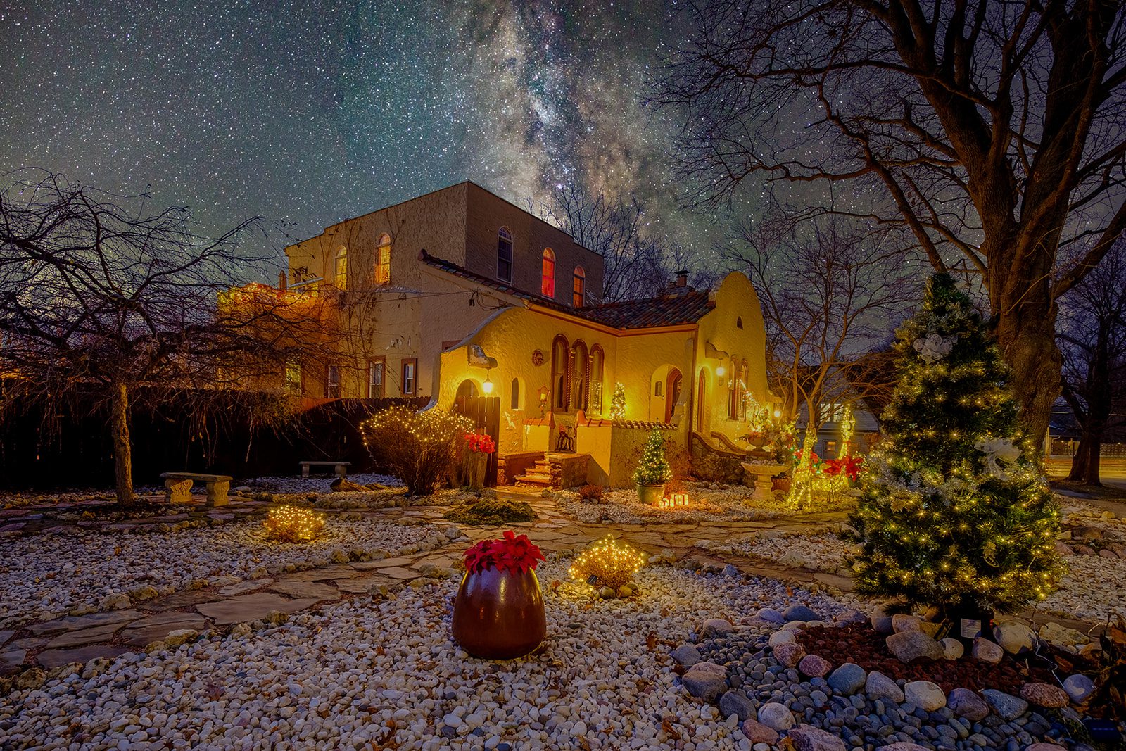A painting of a house with christmas lights