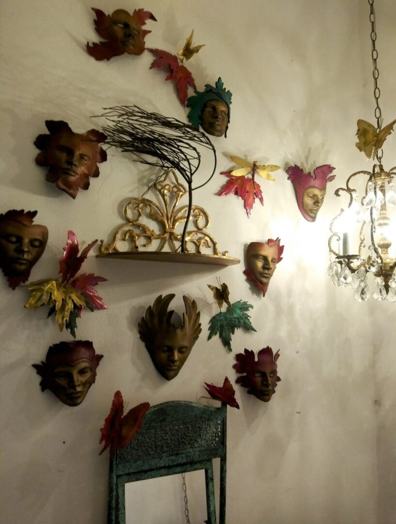 A wall with many masks hanging on it