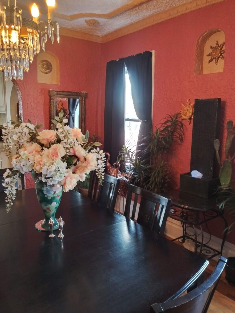 A dining room table with flowers in it