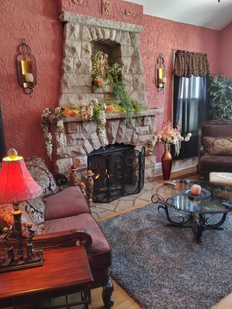 A living room with a fireplace and pink walls