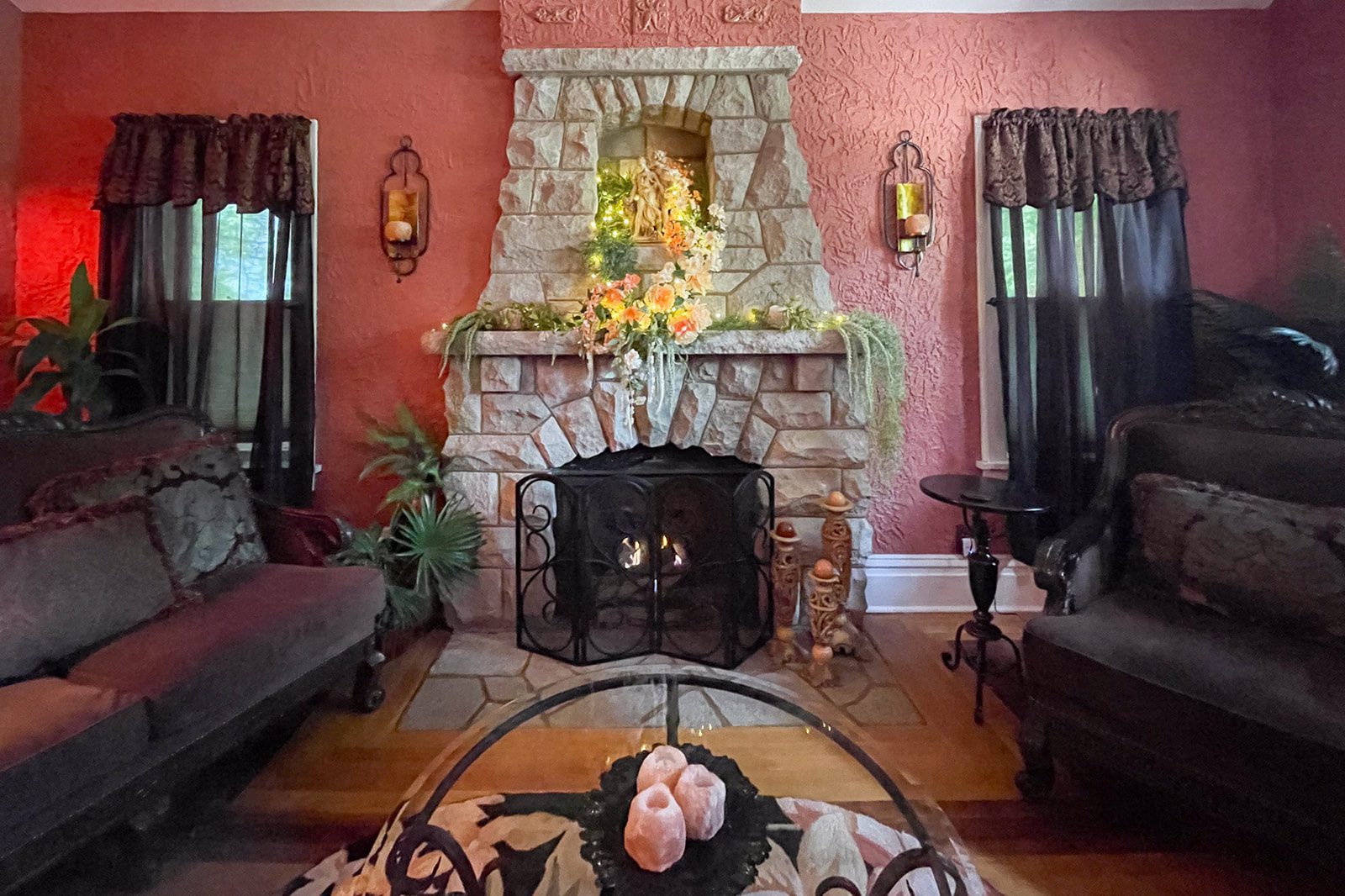 A living room with a fireplace and pink walls